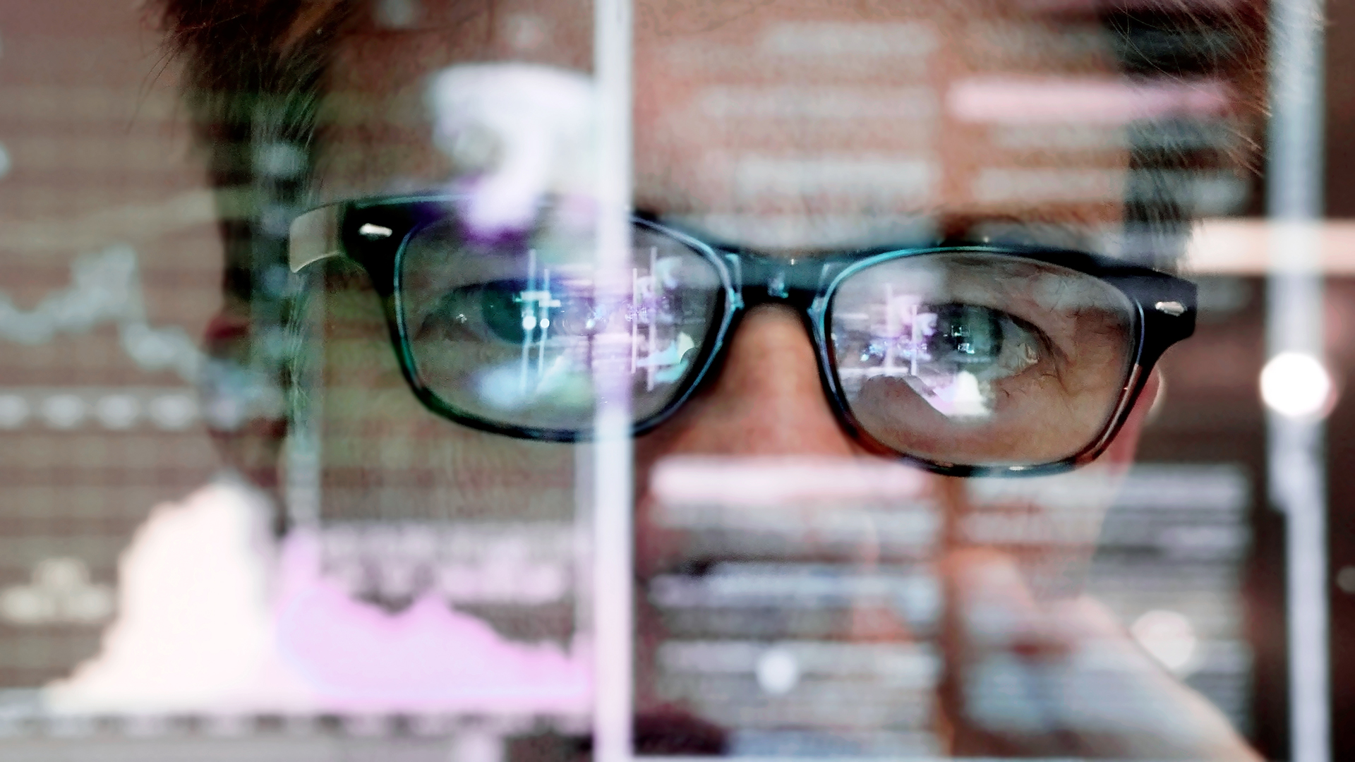 A mature man concentrating on a touch screen display