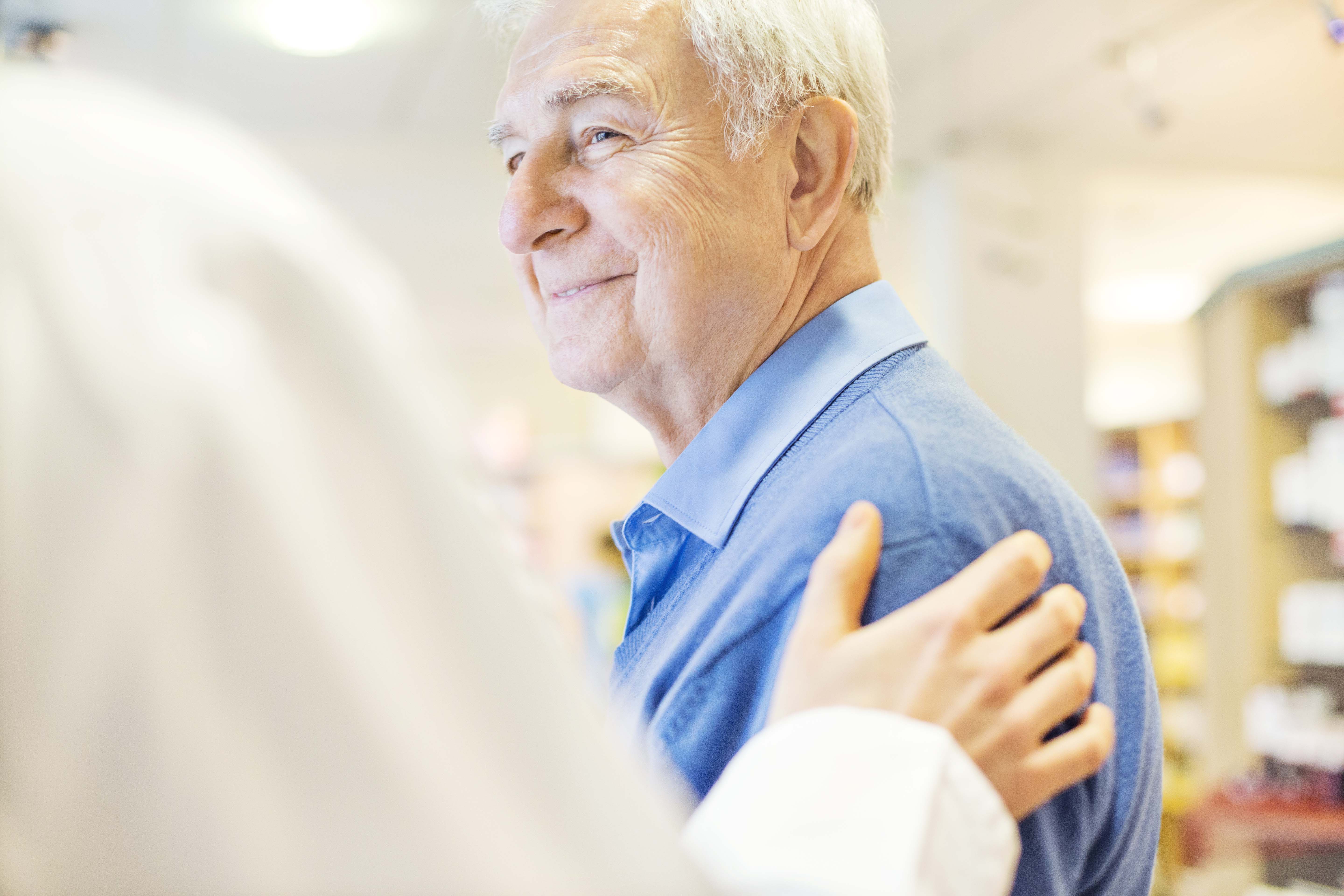 Smiling senior man looking at doctor
