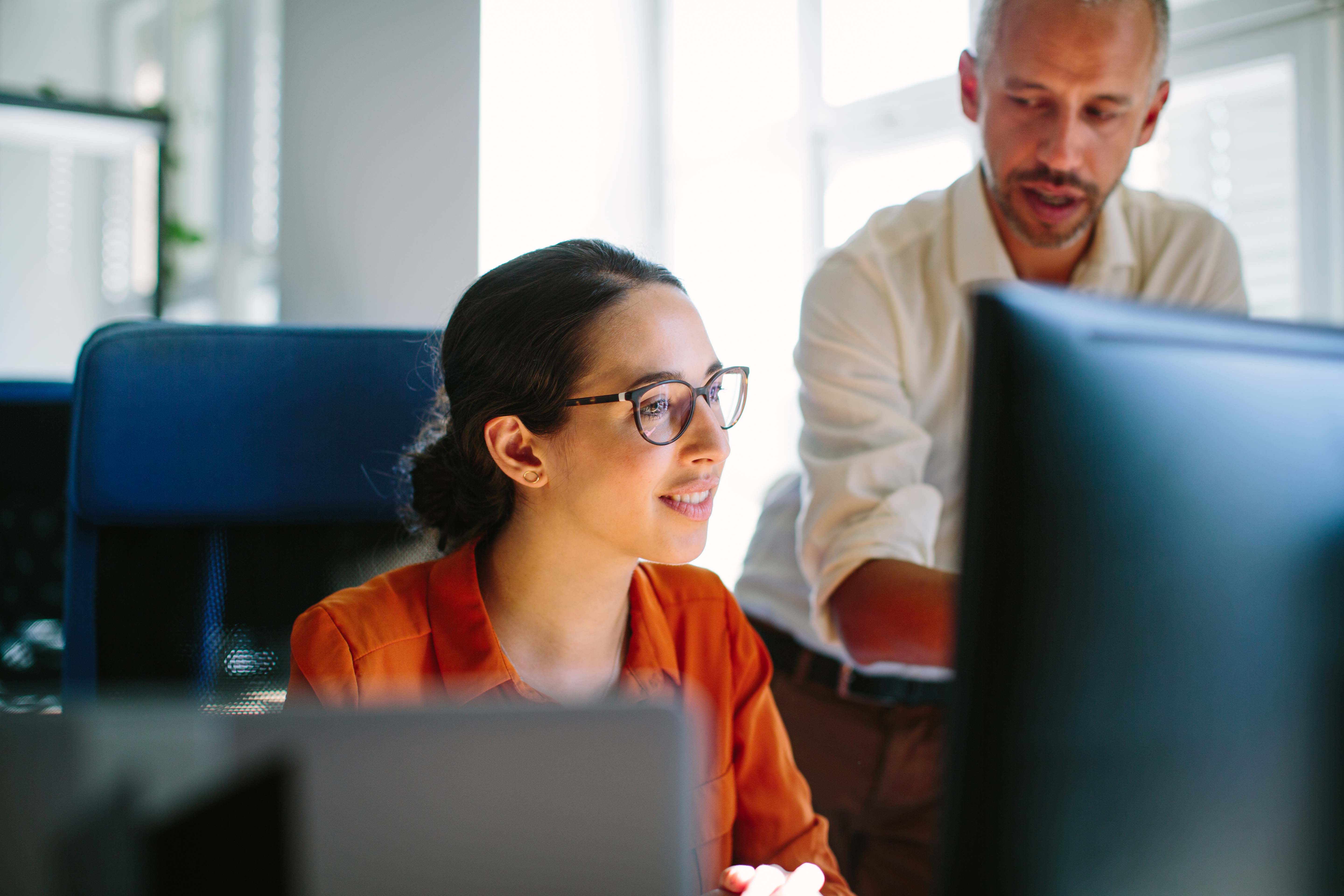 Two Computer programmers looking at a screen