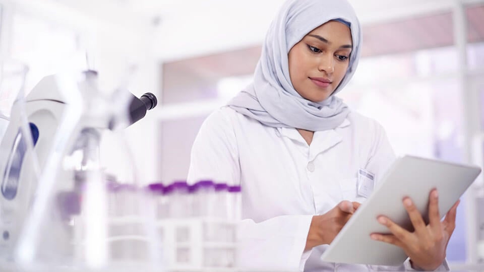 Shot of a young scientist using a digital tablet in a lab