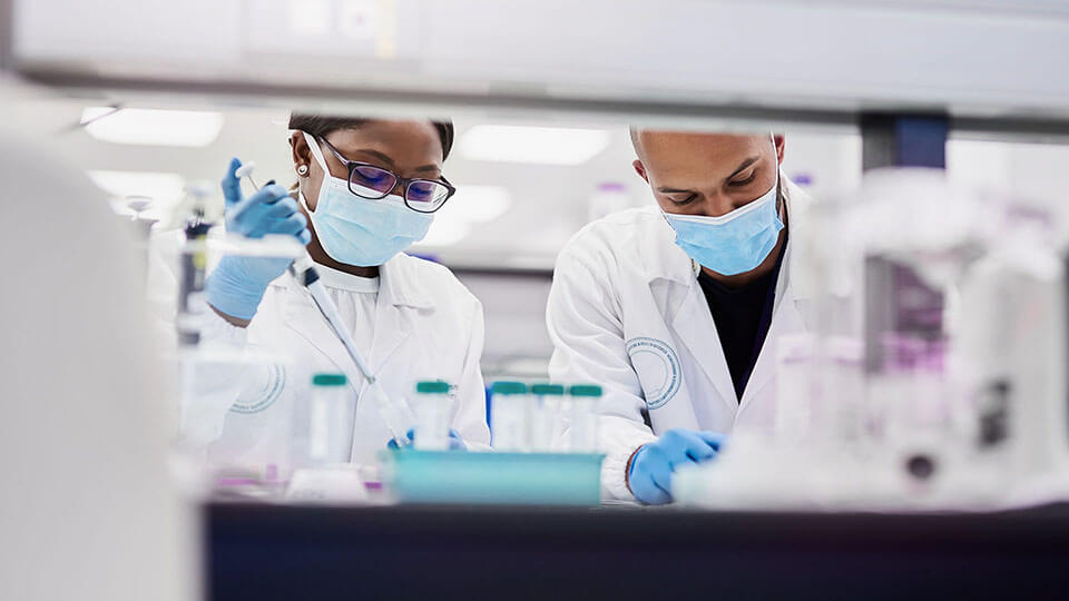 Shot of two young scientists conducting medical research in a laboratory stock photo