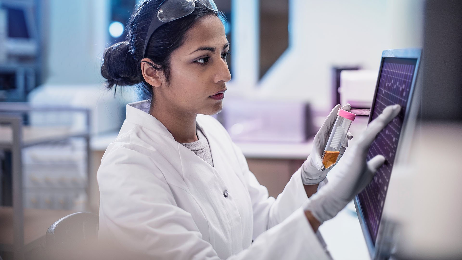 Clinical lab technician analyzing test sample