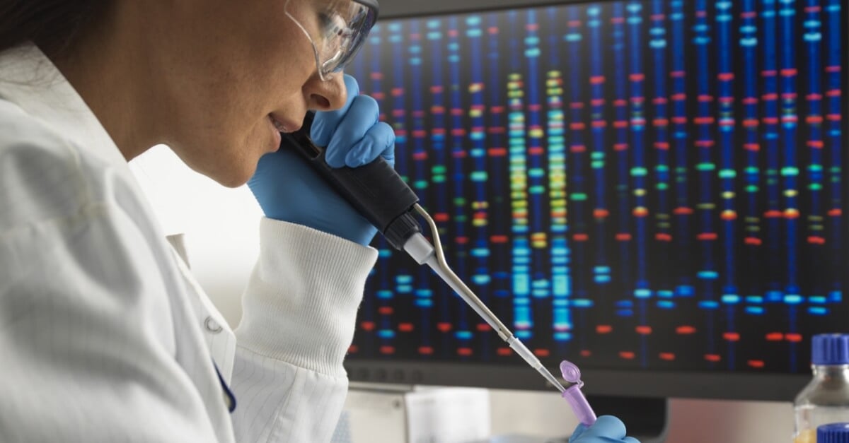 Scientist pipetting DNA (deoxyribonucleic acid) samples for testing during a clinical trial