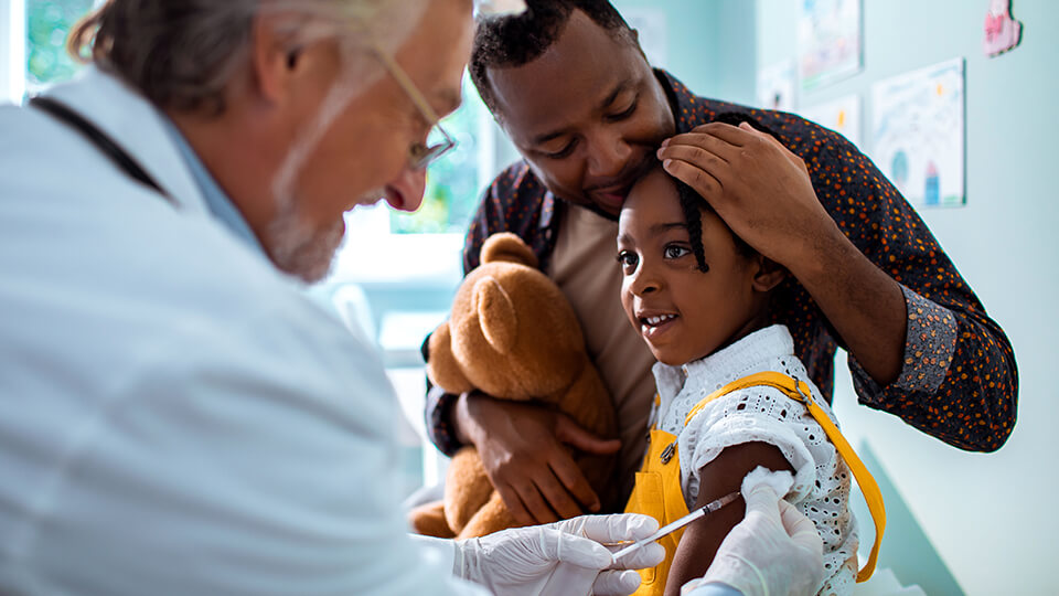 Doctor giving boy shot