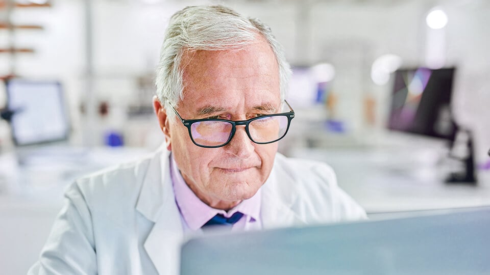 Shot of a senior scientist working on a laptop in a lab