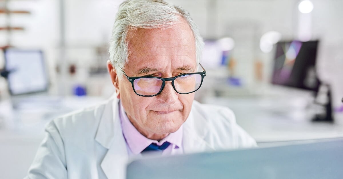 Shot of a senior scientist working on a laptop in a lab
