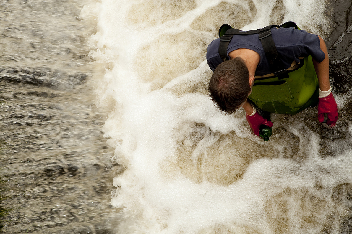 Taking samples of the soil and water, environmental research.